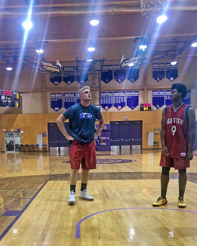 Alex in a gym playing basketball