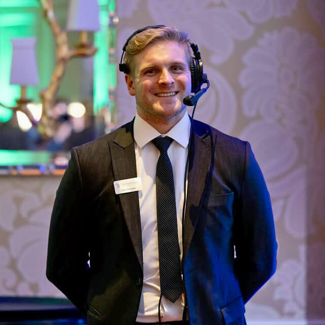 Alex working an event while wearing a radio headset